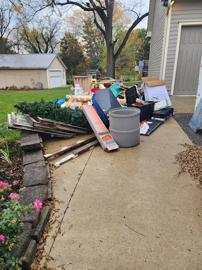 Dumpster being loaded with debris for Estate Cleanout Dumpster Rental in Hamlin